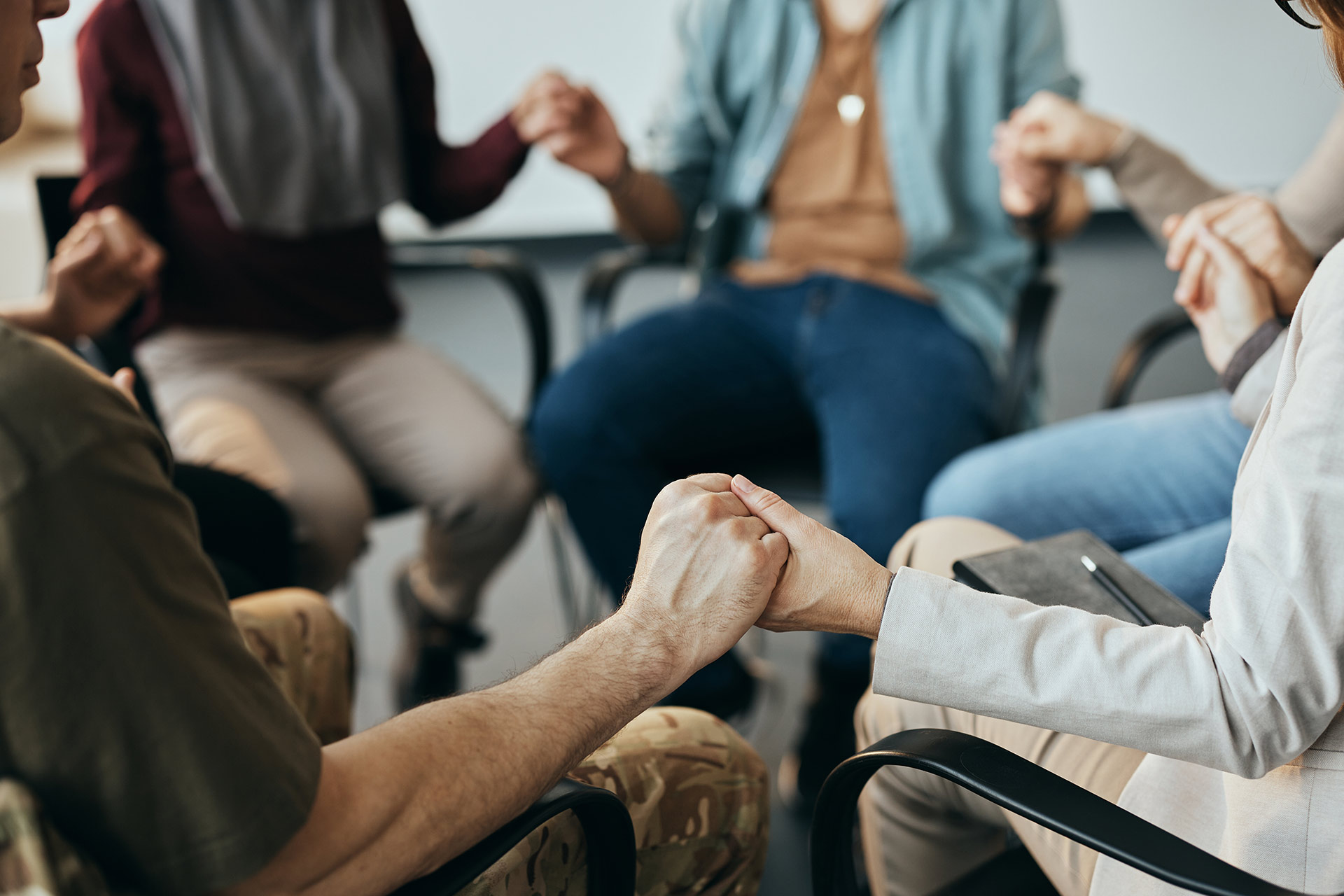 close-up-of-group-therapy-attenders-holding-hands-DGUQWYG.jpg